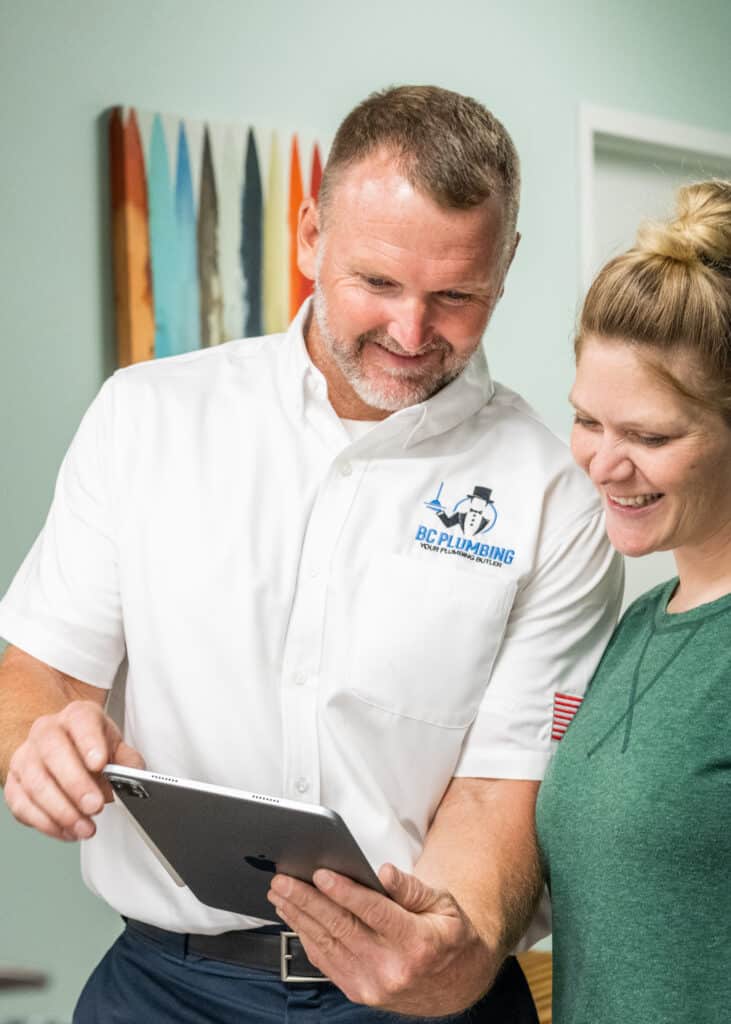 A BC Plumbing Technician discusses the repair findings with a client.